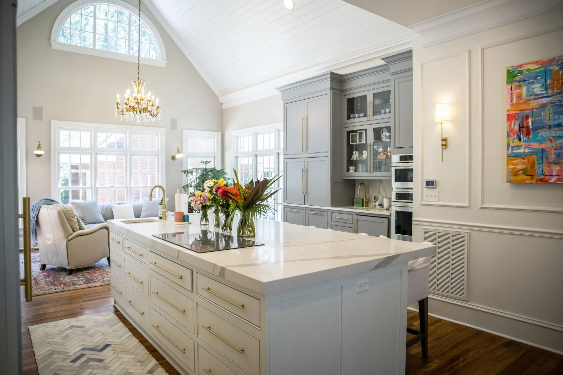 Bright, clean kitchen and living space with marble island