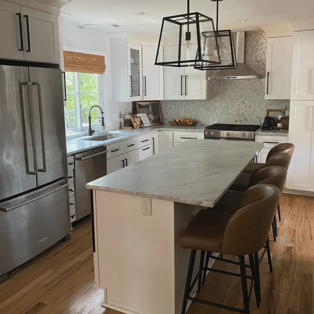Clean white kitchen with marble island