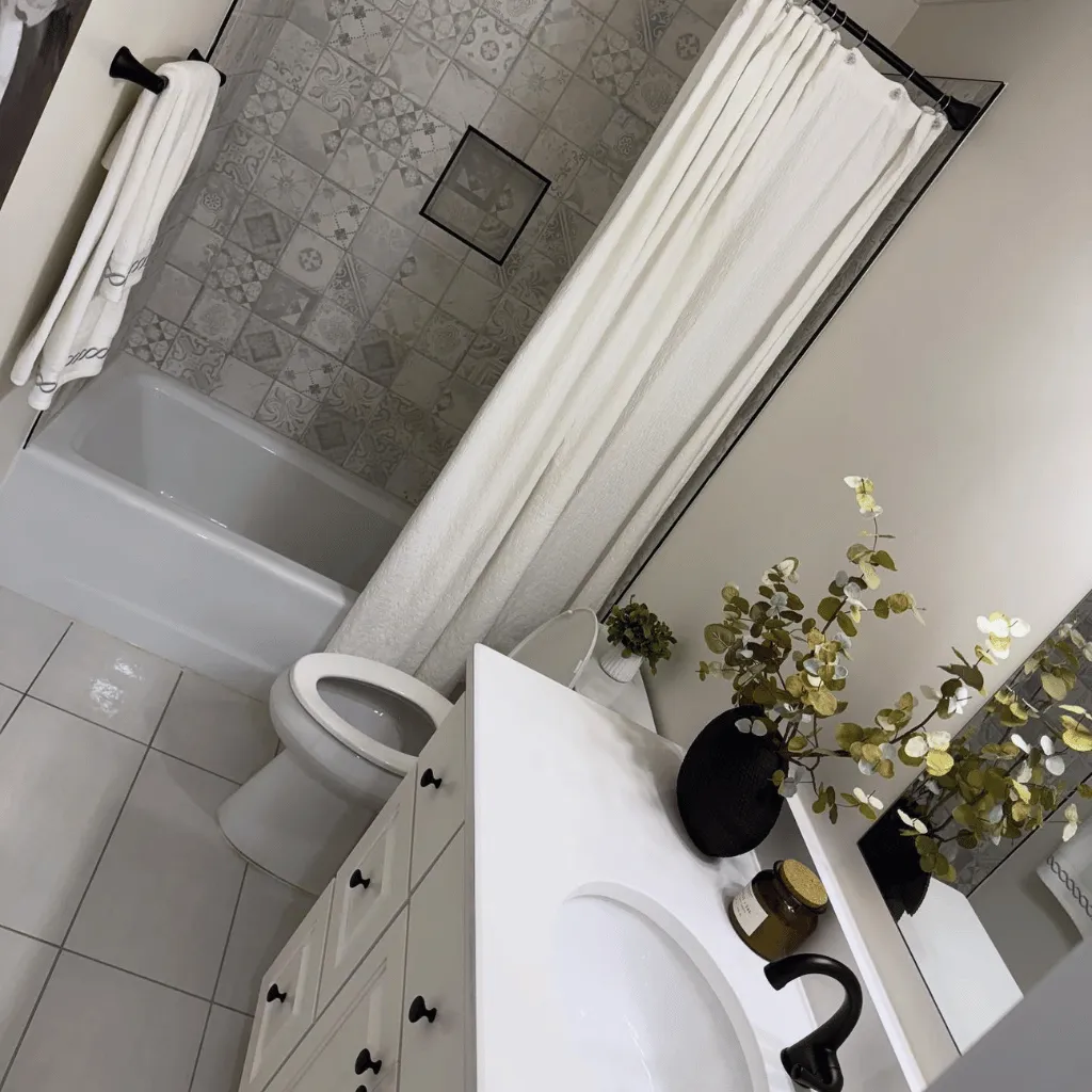 Spotless bathroom with tiled shower and vanity