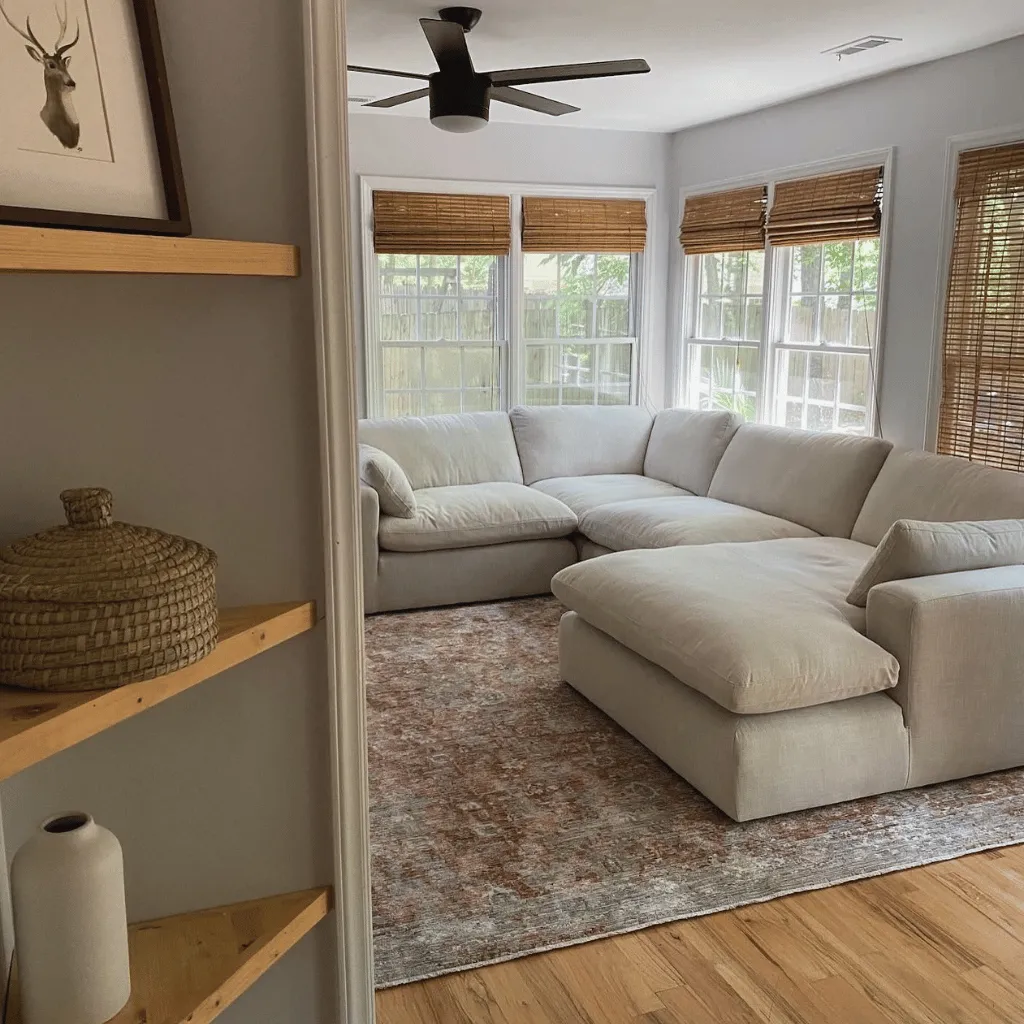 Clean living room with sectional and area rug